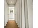 Hallway with curtains leads to a bright bathroom with white cabinets at 2575 Peachtree Ne Rd # 8D, Atlanta, GA 30305