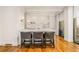 Chic kitchenette with a marble countertop bar seating, and bright light from window at 2575 Peachtree Ne Rd # 8D, Atlanta, GA 30305