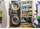 Laundry room with stacked washer/dryer and shelving for storage at 2575 Peachtree Ne Rd # 8D, Atlanta, GA 30305