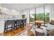 Open living space featuring a bar area, wooden table and large windows that bring nature inside at 2575 Peachtree Ne Rd # 8D, Atlanta, GA 30305