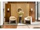 Lobby area featuring two chairs around a decorative table, accent lighting, and wood panel walls at 2575 Peachtree Ne Rd # 8D, Atlanta, GA 30305