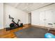 Hardwood floor workout room with a ceiling fan, exposed beams, gym equipment and closet at 2575 Peachtree Ne Rd # 8D, Atlanta, GA 30305