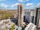Stunning aerial view of a high-rise building with balconies, a pool, parking, and city views under a partly cloudy sky at 3481 Lakeside Ne Dr # 2303, Atlanta, GA 30326