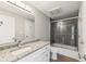Bathroom with granite countertop, updated vanity and tub with glass door at 3481 Lakeside Ne Dr # 2303, Atlanta, GA 30326