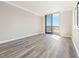 Serene bedroom with hardwood floors, neutral walls, and a sliding glass door leading to a private balcony with scenic views at 3481 Lakeside Ne Dr # 2303, Atlanta, GA 30326