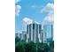 Modern high-rise building with a beautiful blue sky and green trees in the foreground at 3481 Lakeside Ne Dr # 2303, Atlanta, GA 30326