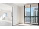 Spacious living room featuring luxury floors, large windows, and glass patio doors at 3481 Lakeside Ne Dr # 2303, Atlanta, GA 30326