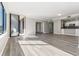 Bright and airy living room featuring wood floors, neutral walls, modern lighting, and a sliding glass door to a balcony at 3481 Lakeside Ne Dr # 2303, Atlanta, GA 30326