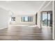 Bright and open living room with sleek flooring, large windows offering city views, and access to a private balcony at 3481 Lakeside Ne Dr # 2303, Atlanta, GA 30326