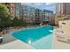 Beautiful community pool with lounge chairs, landscaping, and inviting water for outdoor enjoyment at 3481 Lakeside Ne Dr # 2303, Atlanta, GA 30326