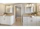 Bright bathroom featuring double vanities with granite countertops and white cabinetry at 3735 Borning Ct, Alpharetta, GA 30022