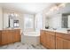 Beautiful bathroom with a soaking tub, double vanities, and marble floors at 1564 Spring Se St, Smyrna, GA 30080