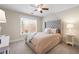 Cozy bedroom featuring a tufted headboard, a ceiling fan, and a bright window at 1564 Spring Se St, Smyrna, GA 30080