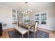 Bright dining room with a long wooden table, bench seating, and views to the front of the home at 1564 Spring Se St, Smyrna, GA 30080