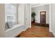 Welcoming foyer with hardwood floors, a window seat, and a stained glass front door at 1564 Spring Se St, Smyrna, GA 30080