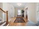 Bright foyer with hardwood floors, a patterned rug, and a wooden front door, creating a warm welcome at 1564 Spring Se St, Smyrna, GA 30080