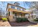 Charming two-story home featuring a welcoming front porch with stone accents and a manicured lawn at 1564 Spring Se St, Smyrna, GA 30080