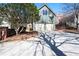 Large two-car garage with ample driveway space and mature trees surrounding the property at 1564 Spring Se St, Smyrna, GA 30080