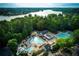 Aerial view of the community pool complex with a lake in the background at 320 Woodlake Ct, Alpharetta, GA 30005