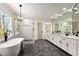 Large bathroom featuring dual vanity sinks, soaking tub, and glass shower at 320 Woodlake Ct, Alpharetta, GA 30005