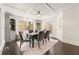 Bright dining room with large windows, stylish lighting, and built-in shelving at 320 Woodlake Ct, Alpharetta, GA 30005