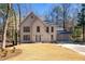 Charming two-story home featuring a three-car garage, and a well maintained lawn at 320 Woodlake Ct, Alpharetta, GA 30005