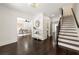 Bright foyer featuring dark wood floors, decorative mirror, and staircase at 320 Woodlake Ct, Alpharetta, GA 30005