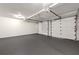Spacious two car garage with gray sealed floor and wainscotting along the wall at 320 Woodlake Ct, Alpharetta, GA 30005