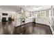 Open concept kitchen with stainless steel appliances, white cabinets, and views to living area at 320 Woodlake Ct, Alpharetta, GA 30005