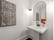 Stylish powder room featuring unique decor and pedestal sink at 320 Woodlake Ct, Alpharetta, GA 30005