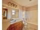 Bathroom featuring single sink vanity, toilet, mirror and shower-tub combo at 326 Rockland Way, Lawrenceville, GA 30046