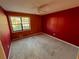 This bedroom features red walls, carpet flooring, and a ceiling fan at 326 Rockland Way, Lawrenceville, GA 30046