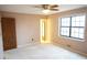 Bedroom with neutral walls, neutral carpet, door, and a window for natural light at 326 Rockland Way, Lawrenceville, GA 30046