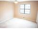 Bedroom with neutral walls, neutral carpet, and a window for natural light at 326 Rockland Way, Lawrenceville, GA 30046
