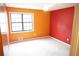 Bright bedroom featuring large window for natural light and vibrant orange and red accent walls at 326 Rockland Way, Lawrenceville, GA 30046
