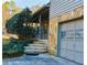 Stone steps leading up to the covered porch with metal railings and a one-car garage at 326 Rockland Way, Lawrenceville, GA 30046