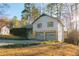 Two-story home with stone accents, two-car garage, and mature landscaping at 326 Rockland Way, Lawrenceville, GA 30046