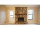Living room showcasing a stone fireplace, and a bright window for natural light at 326 Rockland Way, Lawrenceville, GA 30046
