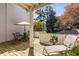 Outdoor patio area with umbrella, table, and chairs offers a perfect setting for entertaining at 3772 Paces Ferry West Se, Atlanta, GA 30339