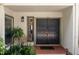 Inviting front entryway with double doors, a decorative lantern, and well-maintained landscaping at 3772 Paces Ferry West Se, Atlanta, GA 30339