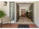 Open double doors reveal a welcoming foyer with decorative bench, rug and plants at 3772 Paces Ferry West Se, Atlanta, GA 30339