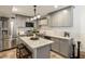 Modern kitchen with grey cabinets, granite countertops, stainless steel appliances, and center island at 3772 Paces Ferry West Se, Atlanta, GA 30339
