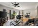 Bright living room featuring hardwood floors, a fireplace, and access to a private balcony at 3772 Paces Ferry West Se, Atlanta, GA 30339