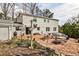 Backyard boasts a brick patio, lush greenery, and access to the home at 800 Glenairy Dr, Atlanta, GA 30328