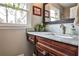 Charming bathroom vanity with marble countertop, wood cabinetry, and stylish fixtures by the window at 800 Glenairy Dr, Atlanta, GA 30328