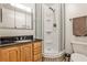 Bathroom featuring a vanity with dark countertops and a glass-enclosed shower stall at 800 Glenairy Dr, Atlanta, GA 30328