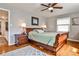 Cozy bedroom featuring a wooden sleigh bed, ceiling fan, hardwood floors, and bright natural light at 800 Glenairy Dr, Atlanta, GA 30328