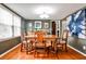 Formal dining room with hardwood floors, stylish light fixture and large window at 800 Glenairy Dr, Atlanta, GA 30328