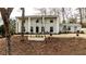 Charming two-story white brick home with a well-maintained front yard and inviting entrance, exuding classic elegance at 800 Glenairy Dr, Atlanta, GA 30328