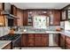 Well-lit kitchen featuring stainless steel appliances, dark wood cabinetry, and light marble countertops at 800 Glenairy Dr, Atlanta, GA 30328